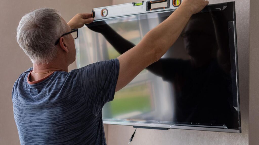 technician installing tv at home