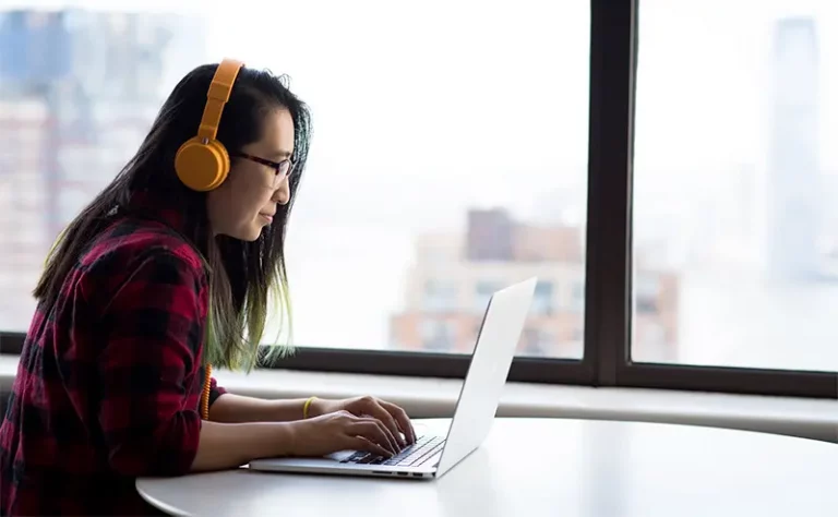 woman transcribing on laptop