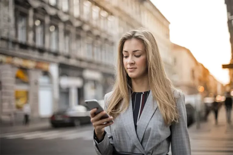 woman walking looking at phone